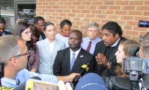 Montravias King speaks, surrounded by supporters from SCSJ, Democracy NC, the NC NAACP, and Rock the Vote.