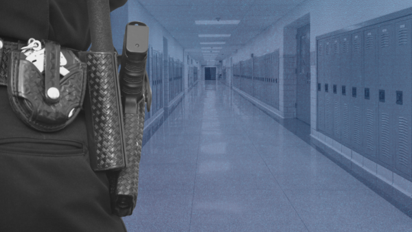 School Resource Officer standing in an empty school hallway